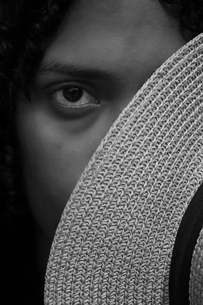 A close up of a person wearing a hat