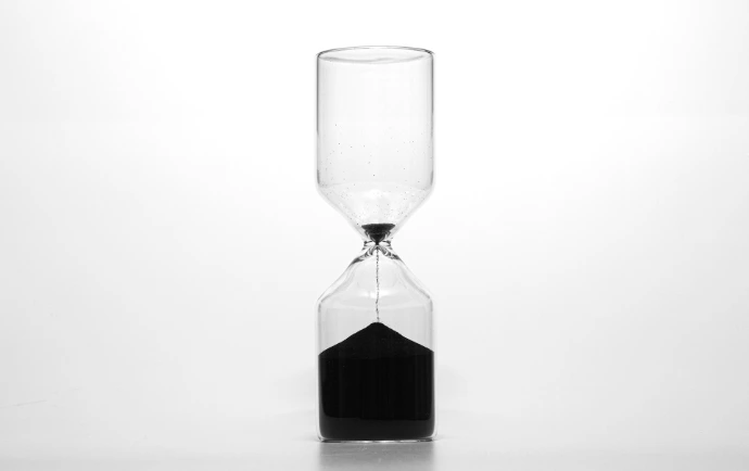 clear glass hour glass with black liquid